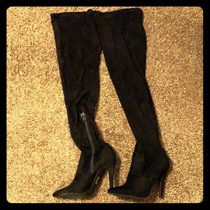 Black knee high boots .